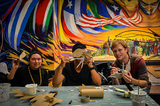 People working on bird sculpture