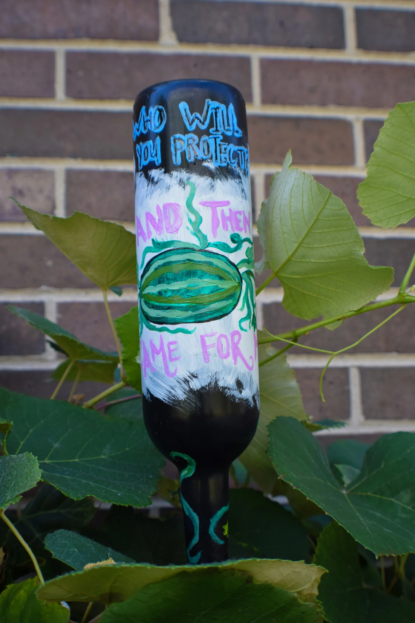 Nour’s bottle with a watermelon vine and a message. Please read the page description.