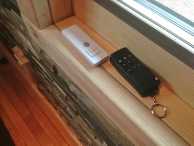  White remote is for overhead halogen lights. Black remote is for turning on white LED lights on trees outside. 