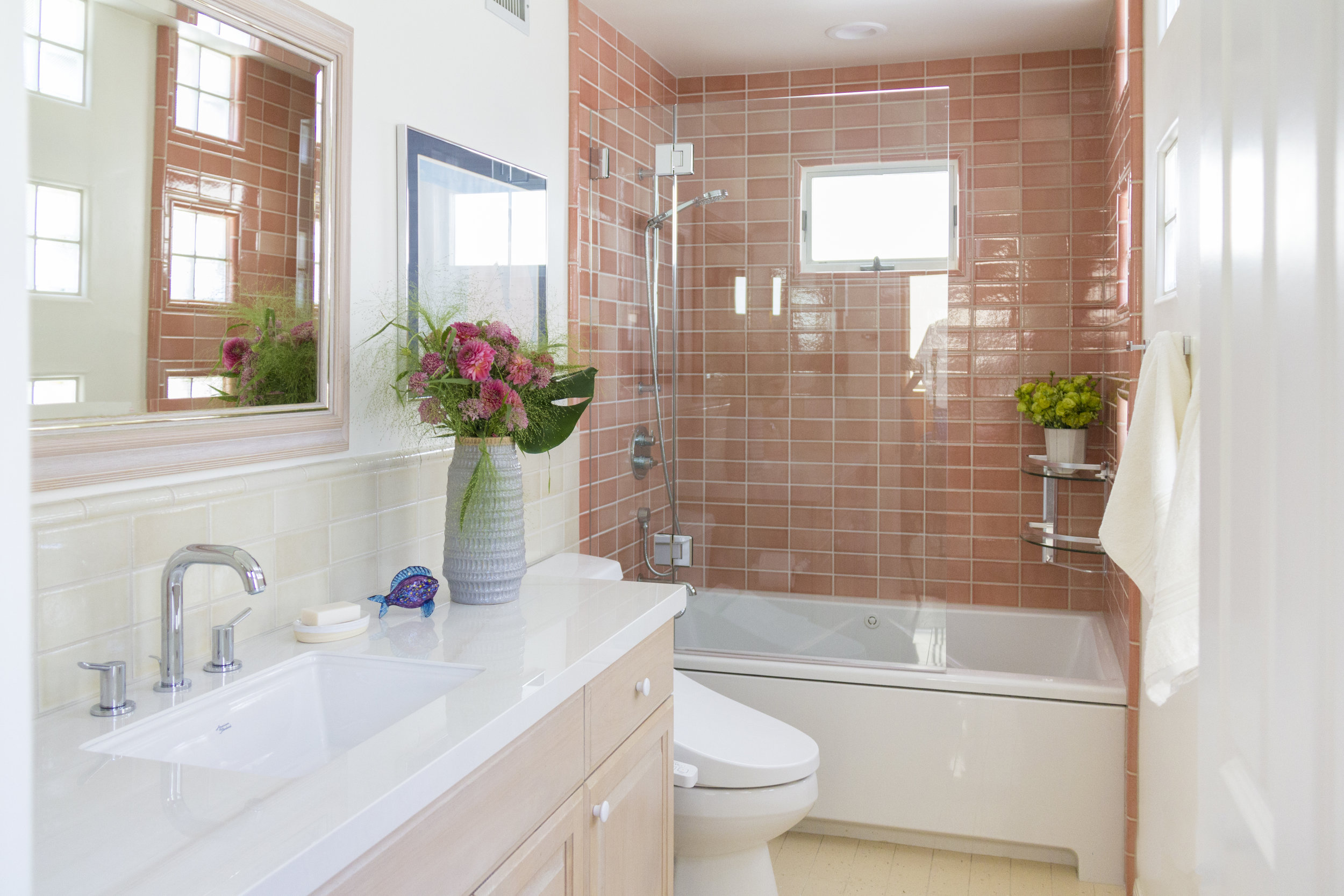 Cheerful coral pink tile pairs beautifully with flowers.