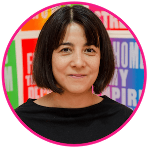 Head shot of Emilie with a bright coloured background