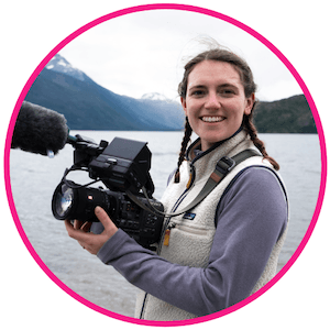 Zoe East smiling whilst holding her camera on one of her adventure shoots.