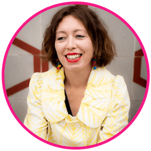 Head and shoulders shot of Katie, with a lovely big smile, looking off to one side.