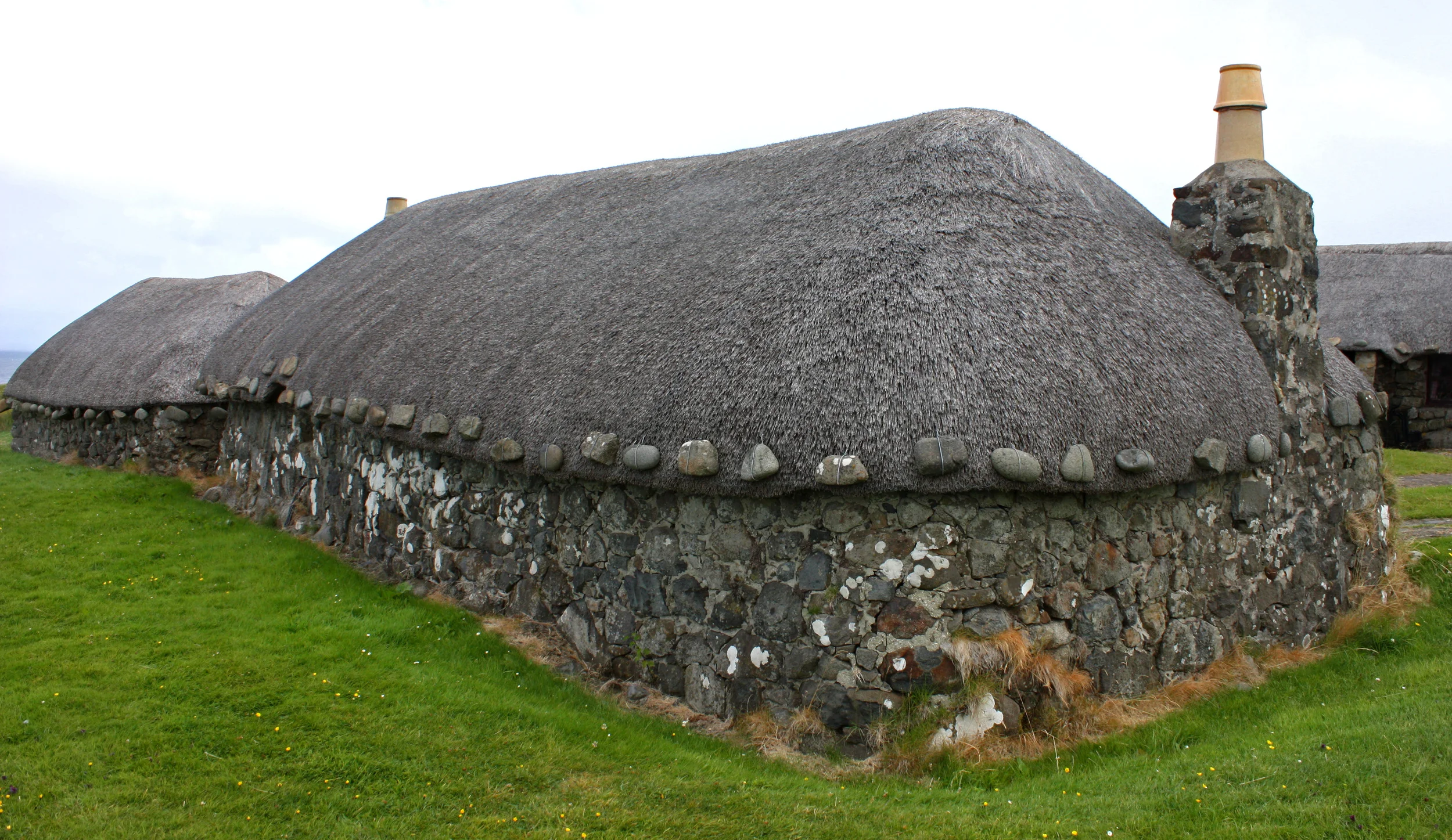 The "tigh dubh" or "black house" is a low set stone building with thatched roof that was common in the Scottish Highlands, the Hebridean islands and Ireland. They are most often associated with crofting (farming)