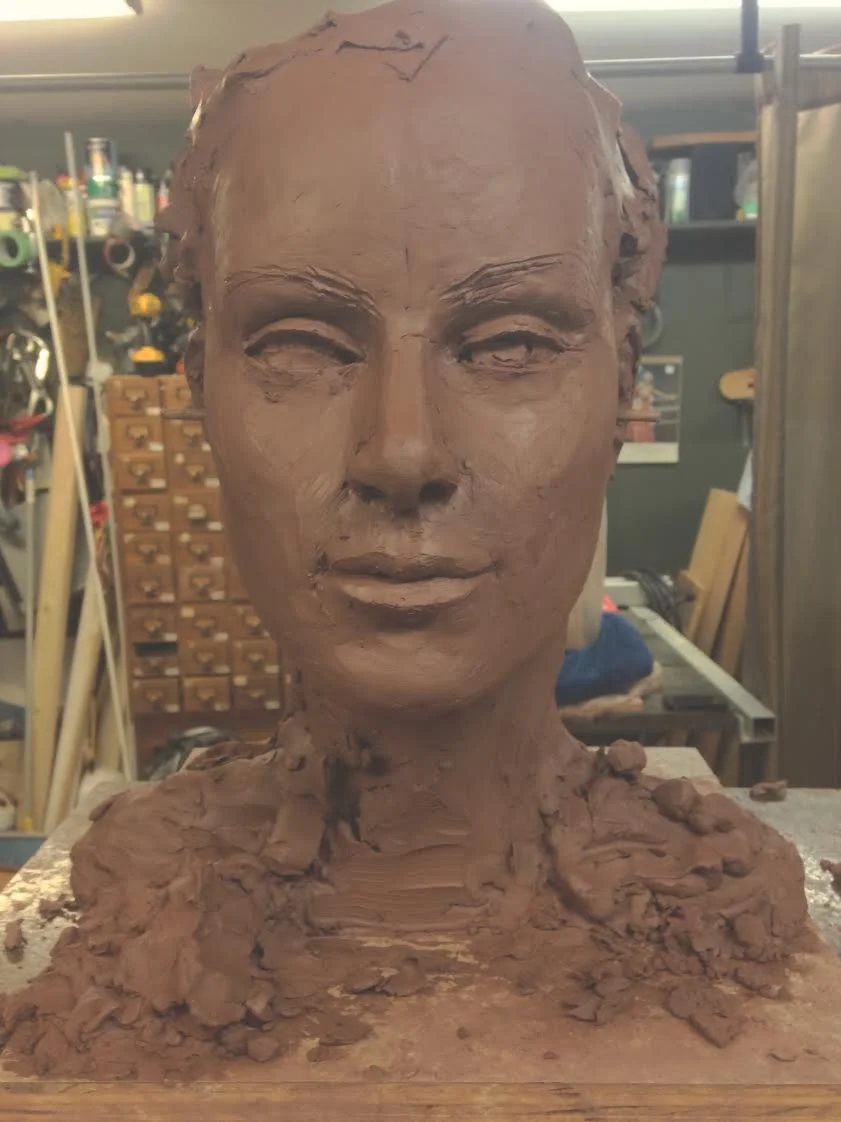 This is what once was a hunk of clay, turned semi face shaped, turned almost complete bust that we are working on. "We" being a loose term, he does 99% of the work.