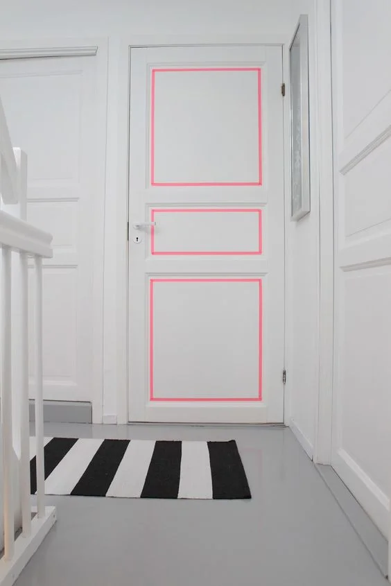 Neon washi tape to make the bad molding on the door look bad in a good way. ( source )