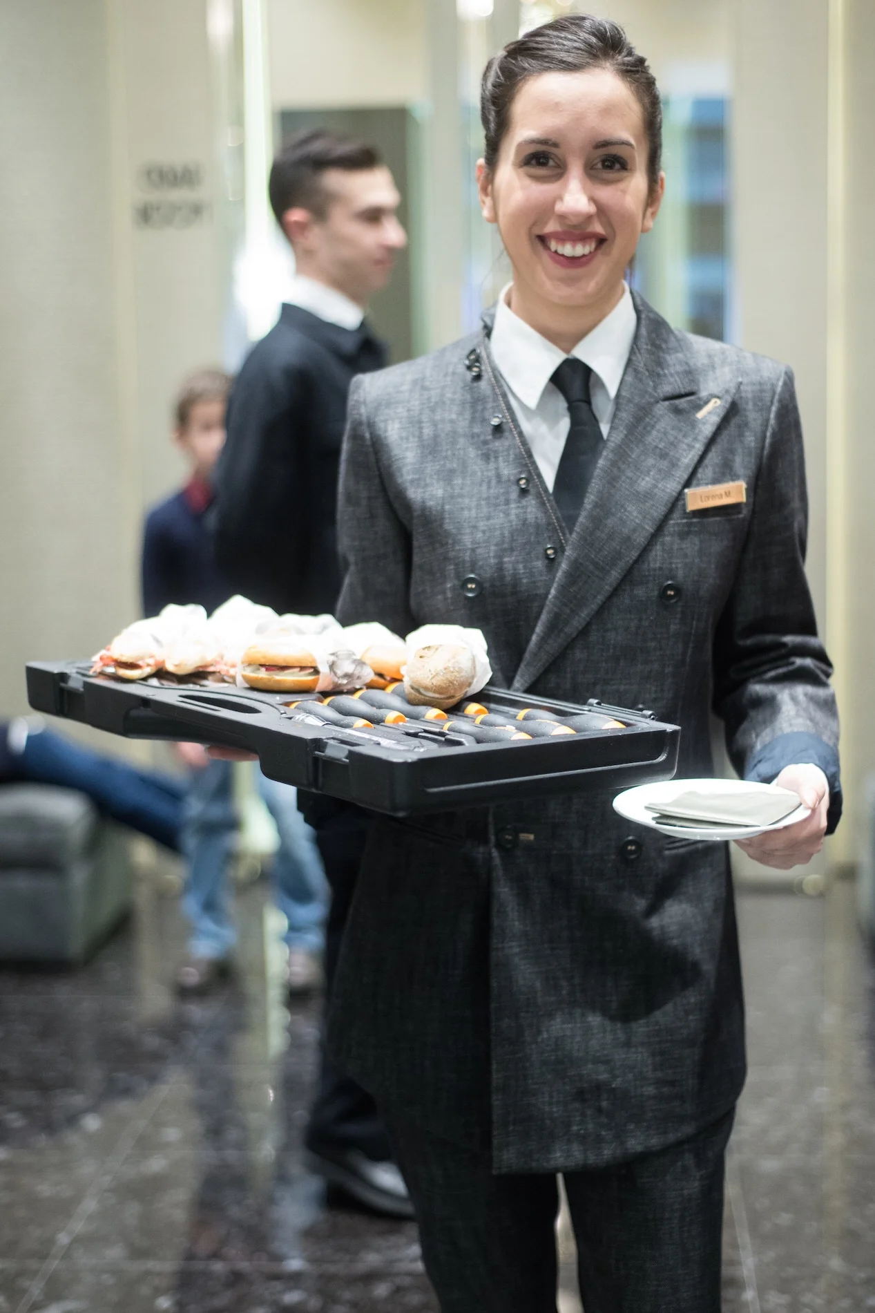 Serving delicious canapés staff in Gentucca Bini trouser suit 