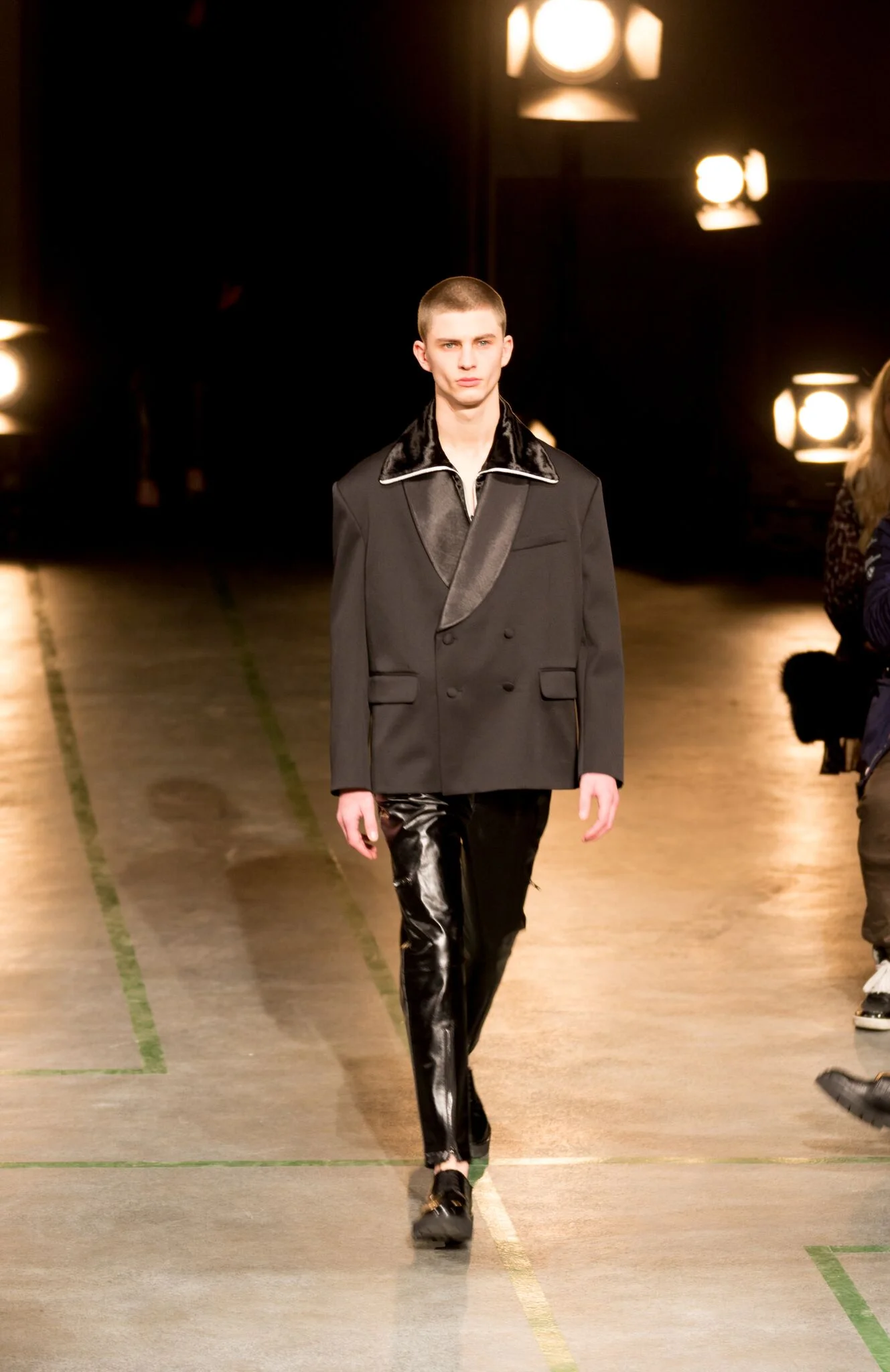 Spread out collars layered with tapered leather trousers.