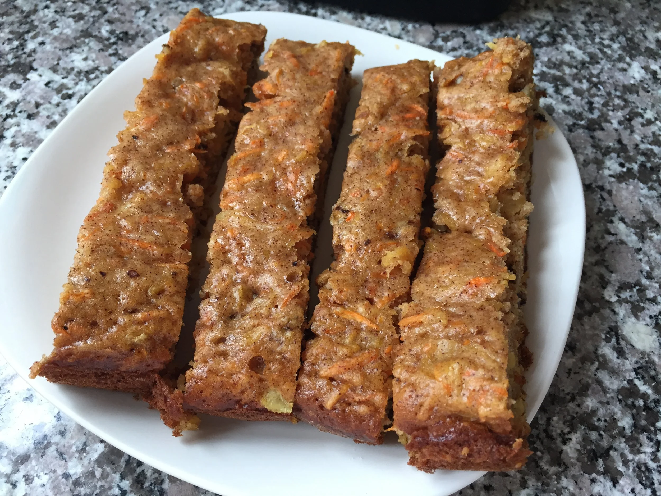 As temperatures start to dip I love to reach for warming treats and these carrot cake bars hit the spot. Crushed pineapple provides moisture and sweetness to this old time favorite fall treat. Warm from the over or slightly heated in the microwave makes these bars a favorite. Dust with confectionary sugar for an extra touch of sweetness. 