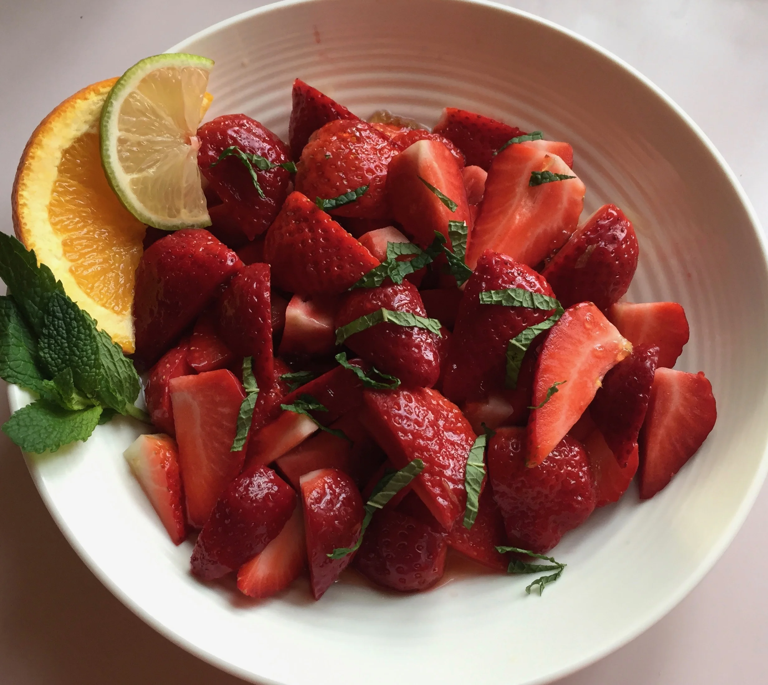 A few drops of a citrus syrup is all it takes to turn plain strawberries into a refreshing dessert! For recipes email: anna@eatingfromwithin.com