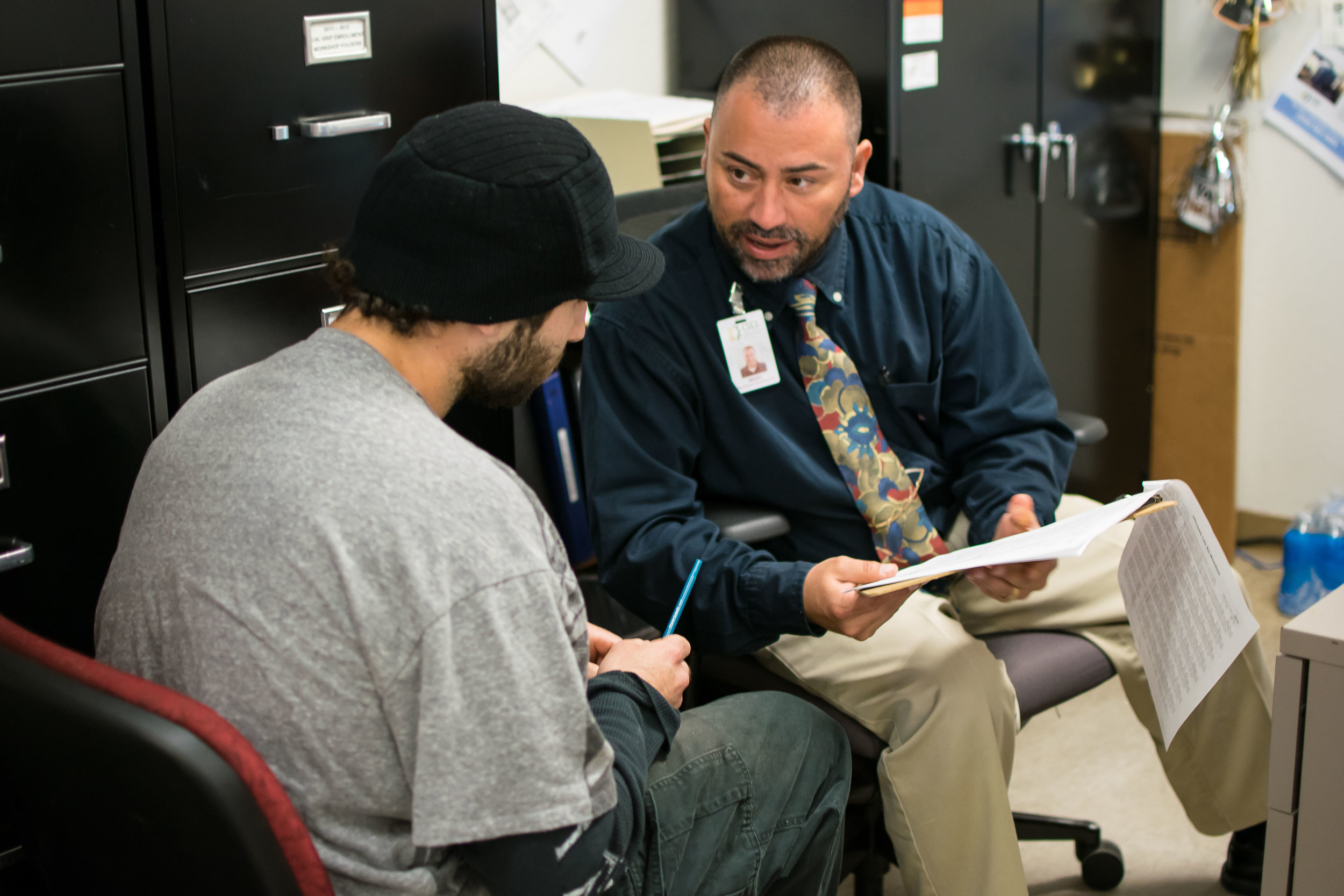 CSET Senior Program Specialist Miguel Castaneda assists a resident with their tax return during the 2016 tax season..jpg