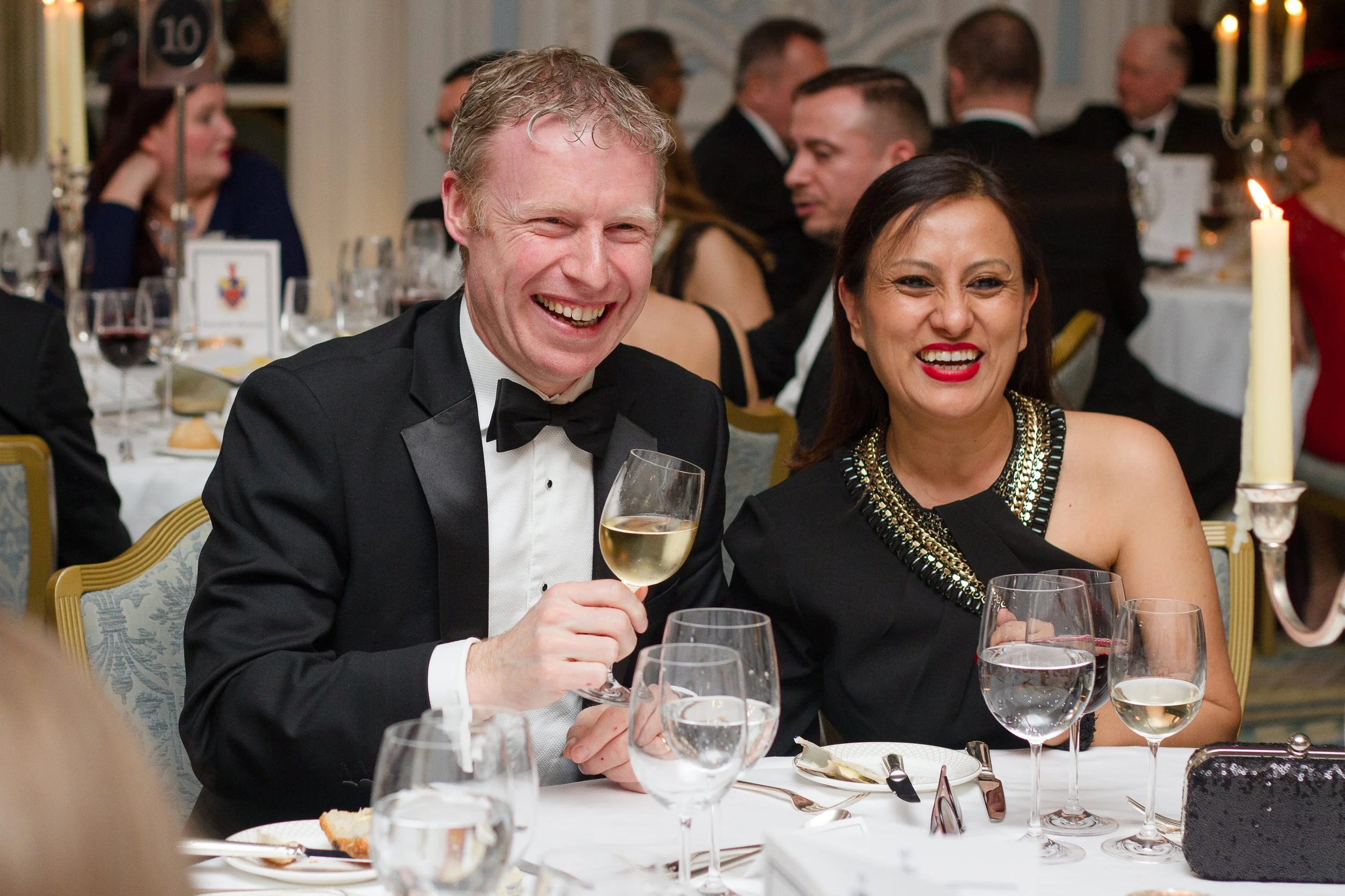 Thomas and Arati Kilroy smiling at a formal black tie dinner