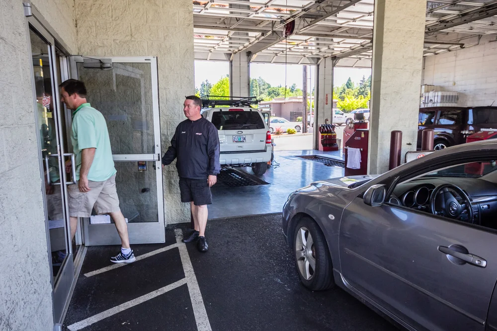 mechanic at Tigard Fast Lane Oil Change working on a car engine