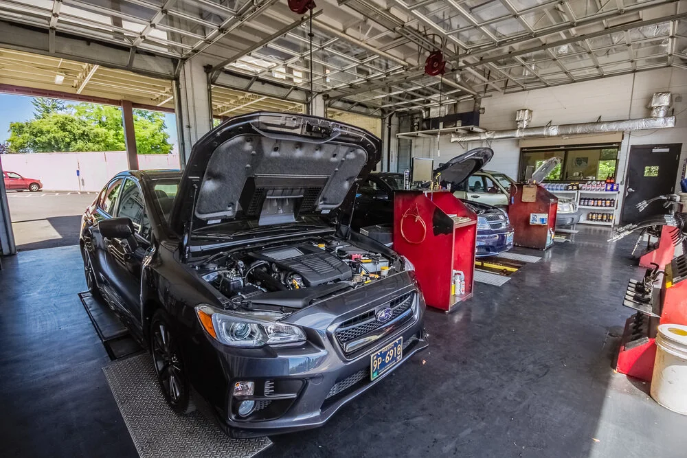mechanic at Tigard Fast Lane Oil Change working on a car engine