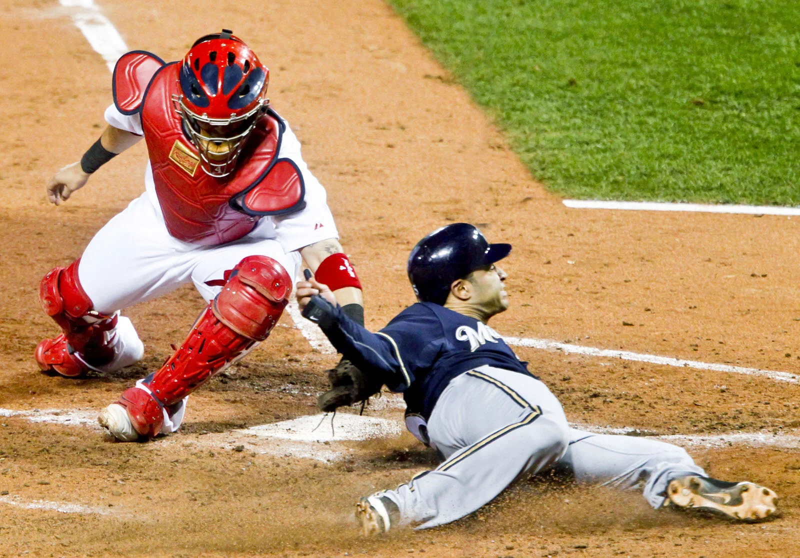  Milwaukee Brewers'&nbsp;Jerry Hairston slides safely into home&nbsp;in front of St. Louis Cardinals catcher Yadier Molina in the fourth inning of Game 4 of the MLB NLCS baseball playoffs in St. Louis, Mo., on October 13, 2011. 