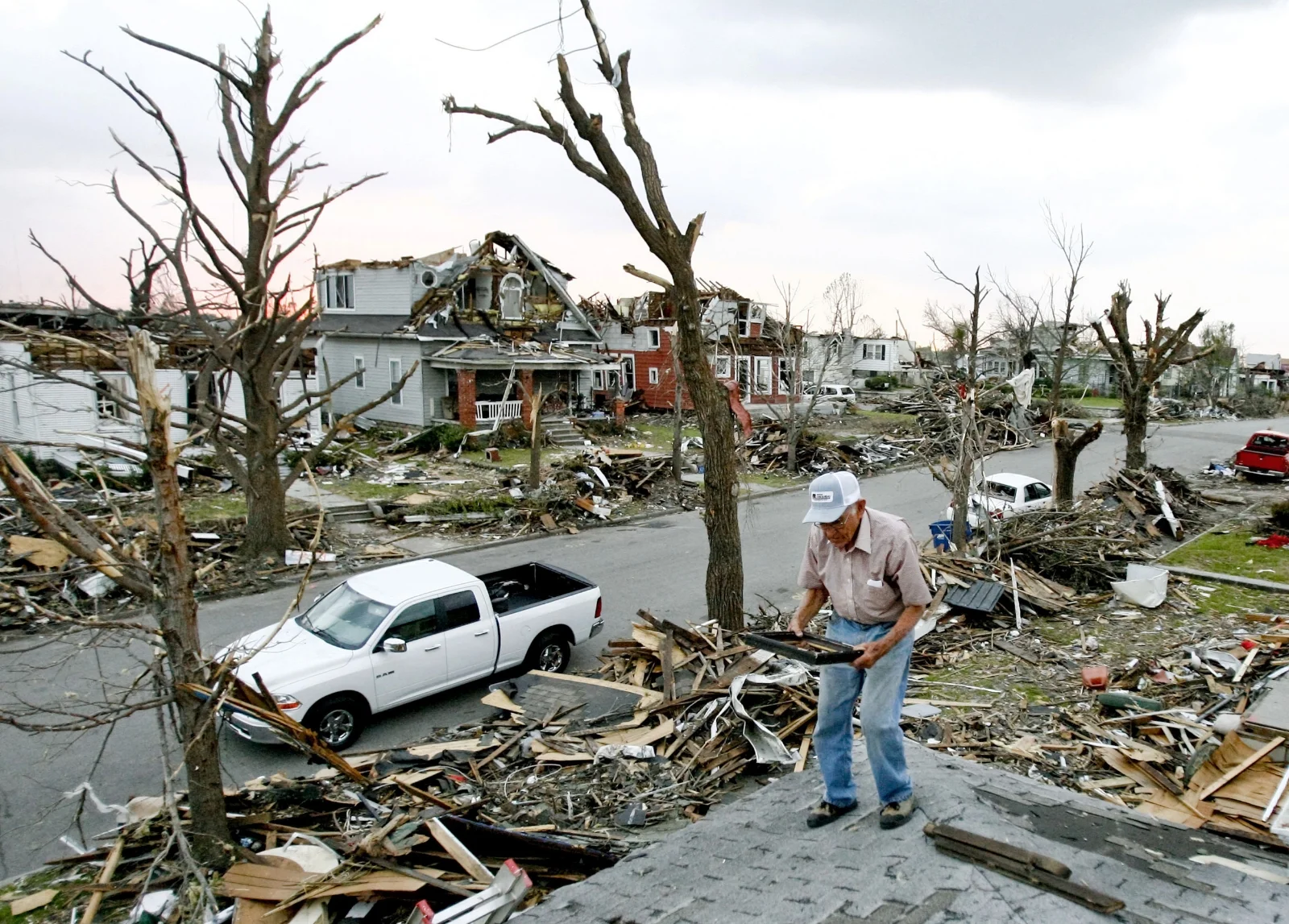 Hugh Hills salvages items from the roof of his house in Joplin, Mo., Tuesday, May 31, 2011.  His house was one of many destroyed in the EF-5 tornado that struck Joplin on May 22, 2011. 