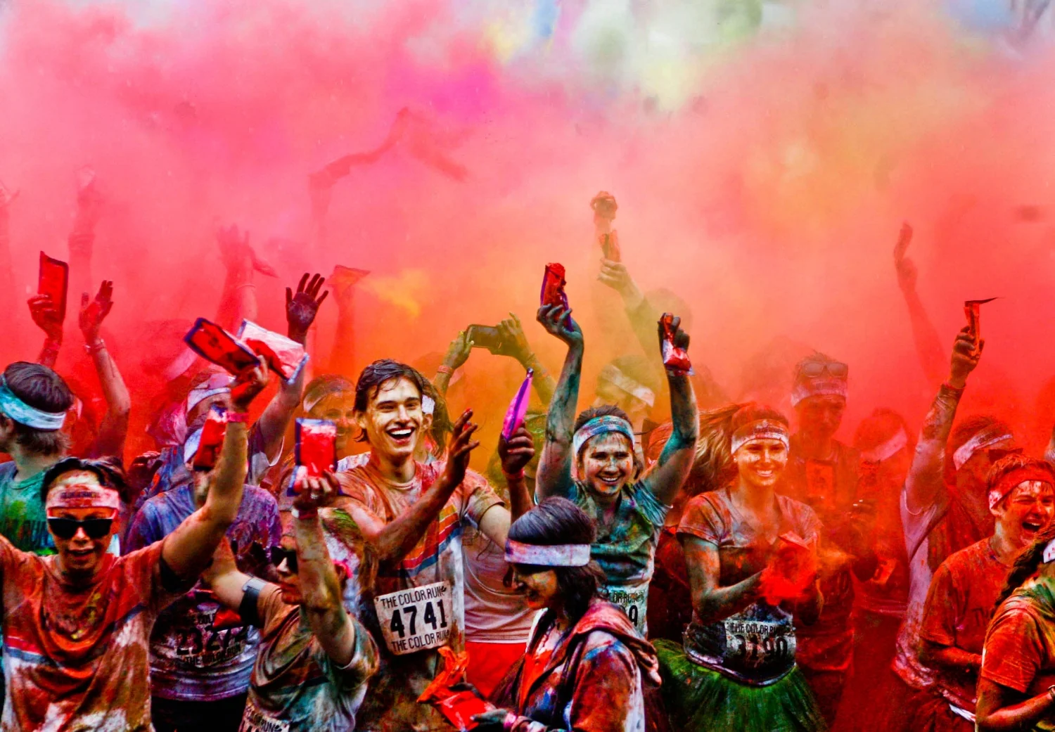 Participants celebrate with a color toss after the Color Run in St. Louis, Mo., Saturday, April 27, 2013.
