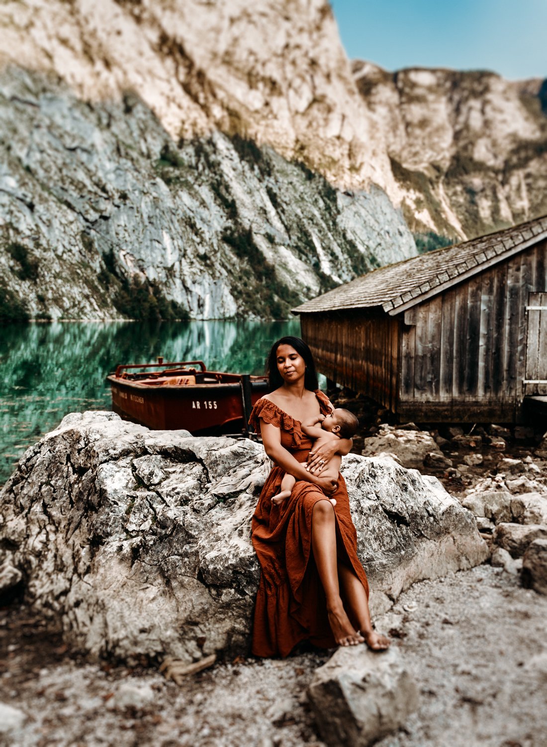 young-mother-brestfeeding-her-baby-sitting-by-a-lake-house-in-long-orange-dress-emotive-storytelling-family-photography-by-sarah-havens-ramstein-kaiserslautern-kmc-germany - Copy.jpg
