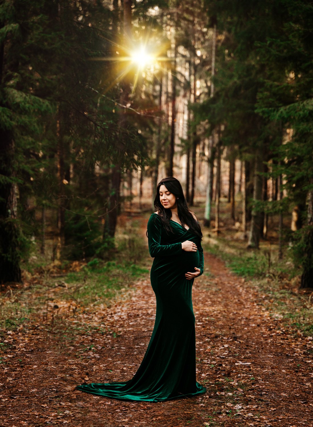 young-mother-to-be-in-green-maternity-dress-in-pine-tree-forest-at-sunset-for-portrait-by-ramstein-family-photographer-sarah-havens-kmc.jpg