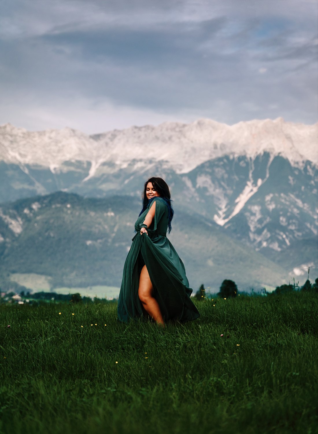 beautiful-young-woman-in-green-dress-in-austrian-alps-dancing-and-smiling-contemporary-storytelling-portrait-photography-by-sarah-havens-ramstein-kmc-kaiserslautern-germany.jpg