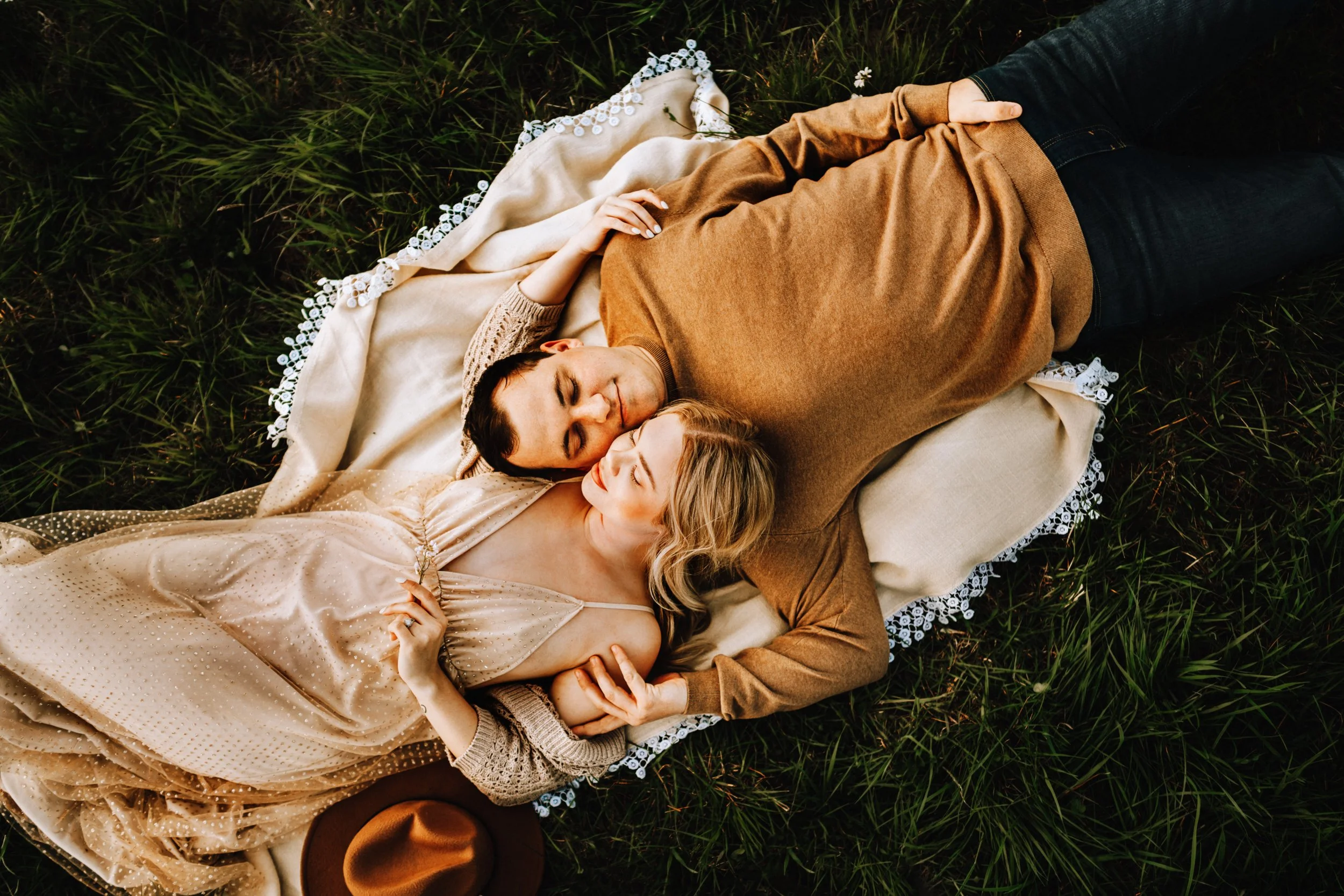 Couple lying on a blanket in a field