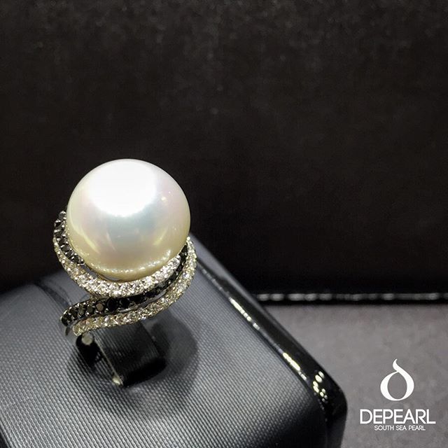 One of our designers' favorites. Sparkling black and white diamonds ring with the rare white pinkish south sea pearl.