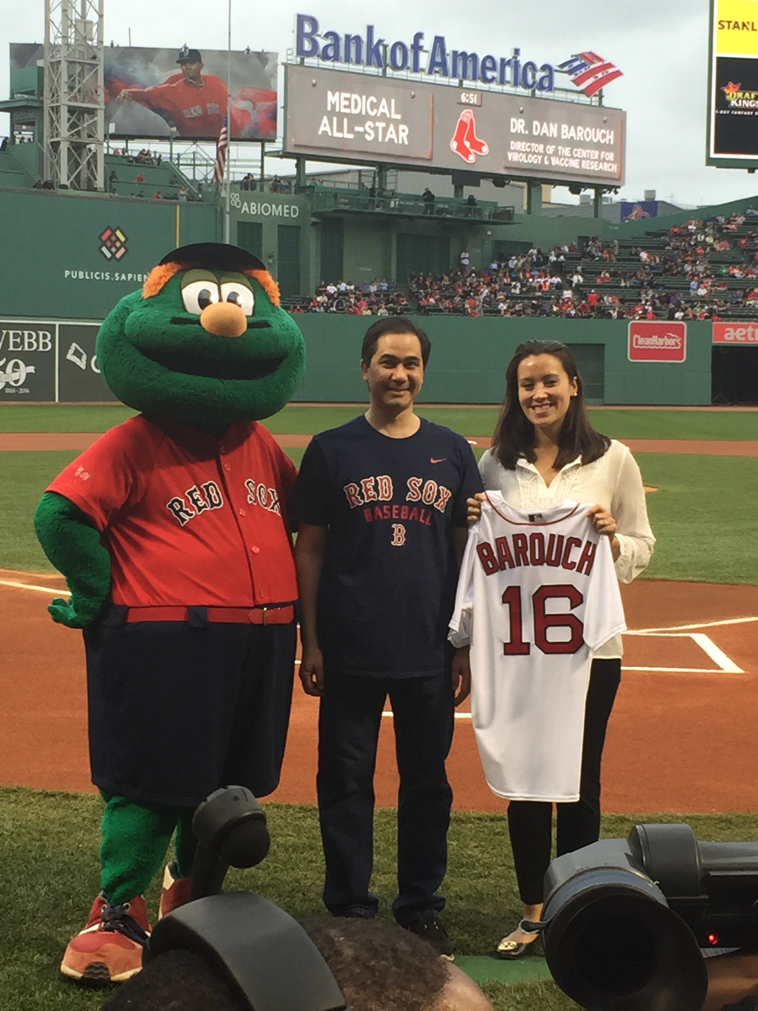 Dr. Barouch and a Red Sox official pose with Wally for a photo opp after being honored as a Medical All-Star.