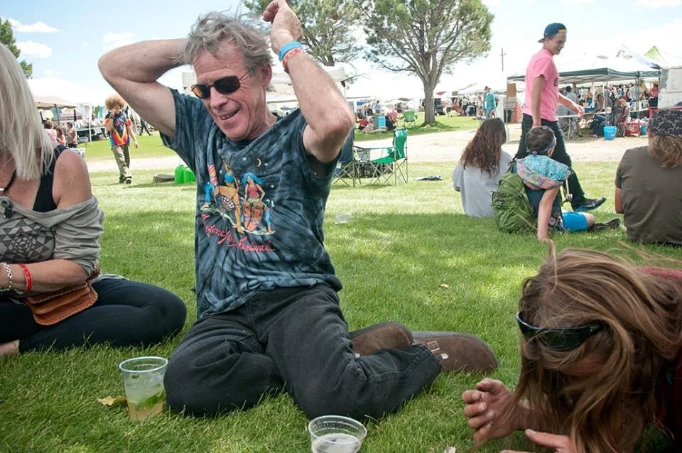 Festivalgoers relaxing together on the grass at an earlier Crestone Music Festival.