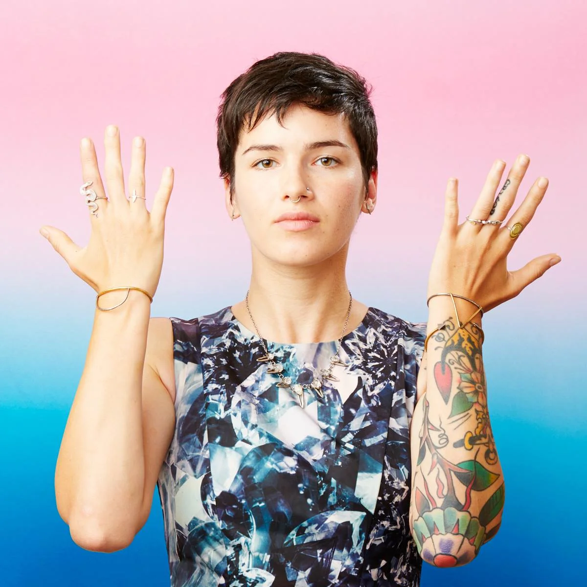 Rhys May poses with some of the jewelry she makes out of metal. Photo by Forrest Aguar.