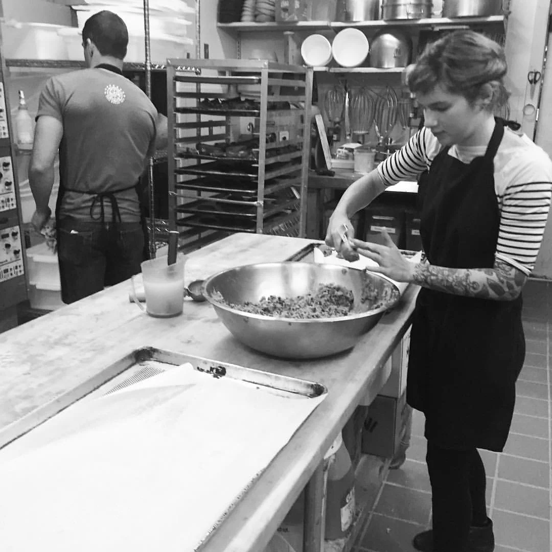 Rhys May in the kitchen at Tart Baking Co., mixes the cookie dough for the giant chocolate chip cookies awarded to race winners. 
