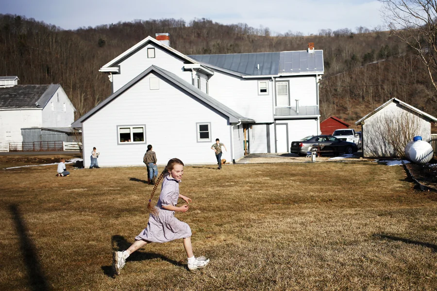 Jennifer Hartzler, 9, runs as she plays tag with friends and siblings behind the Sugar Tree Country Store on Saturday, March 8, 2014, during the Highland County Maple Festival in McDowell, Va. The families of the children were at the country store to sell maple ice cream and maple chicken as a part of the festival.