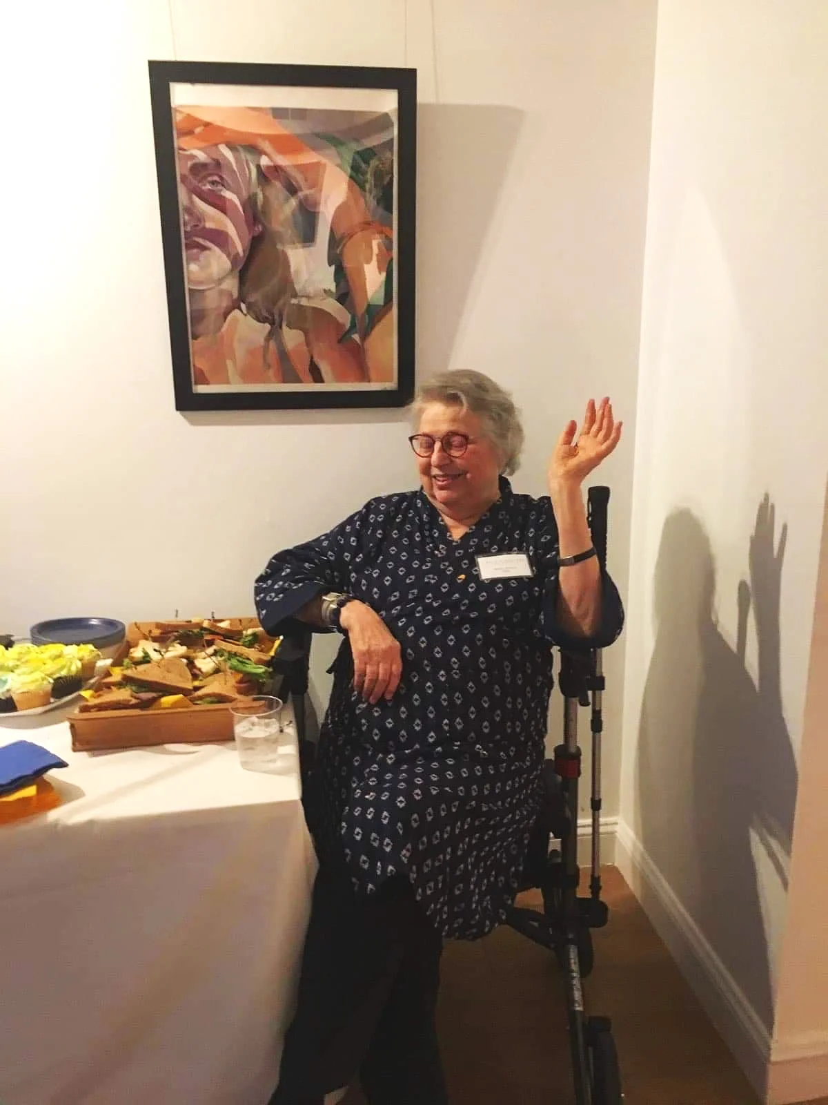 Barb at a Studio Gallery event, waving away compliments on her excellent food display.