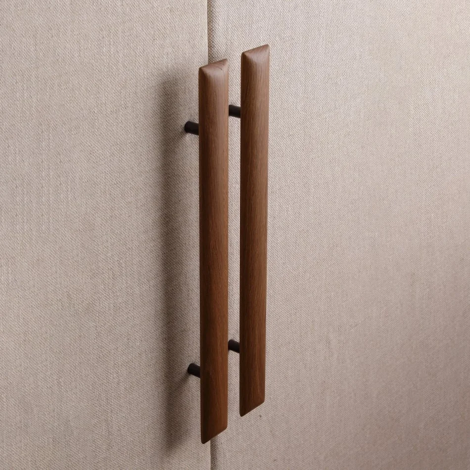 Close-up of a modern wooden door handle mounted on a beige textured wall.
