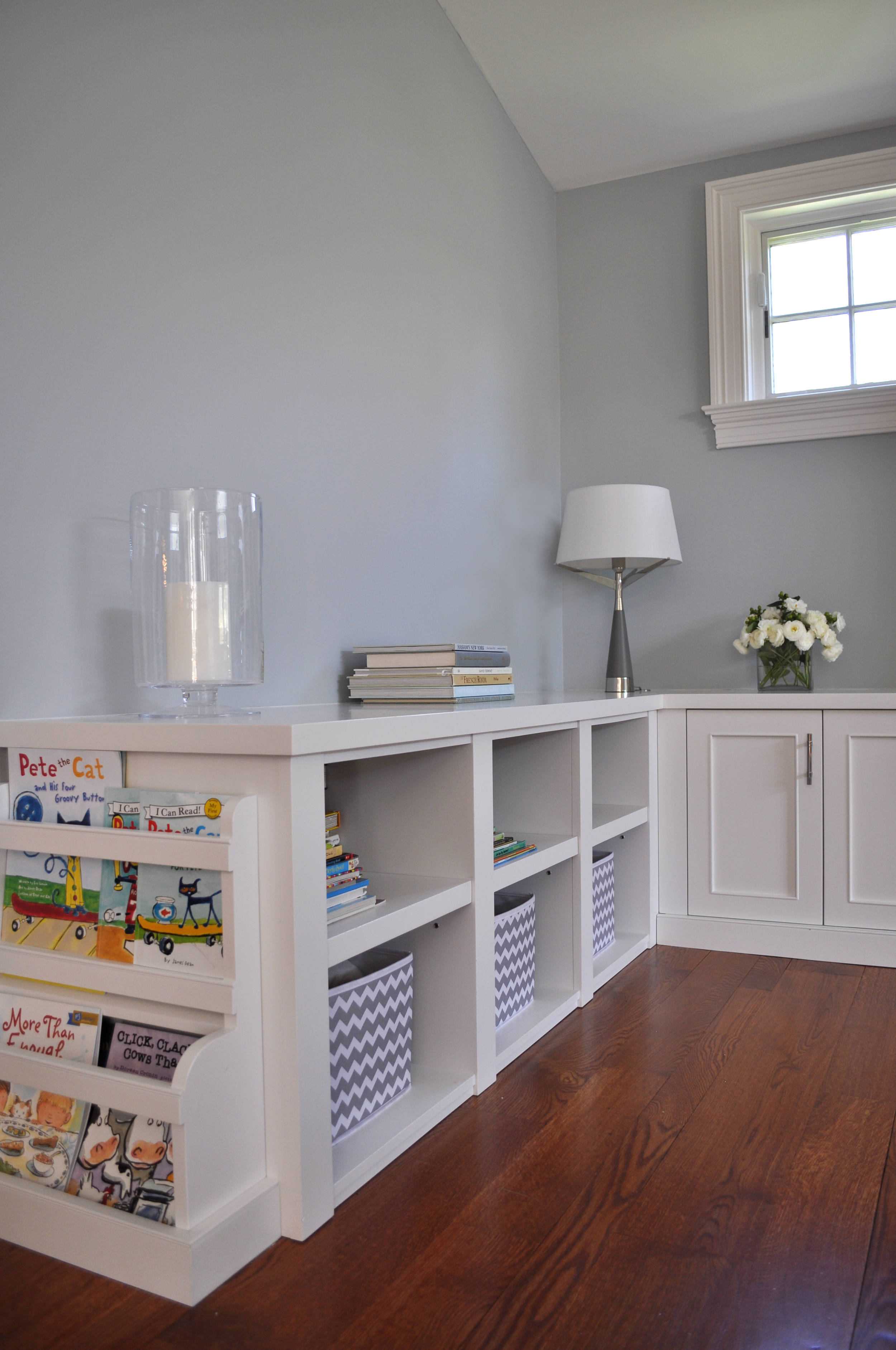 KAM DESIGN_Interior Designer Kim A Mitchell_Transitional Family Room_Gray_Light Blue_Warm Accents__Mamaroneck NY_Custom White Painted Storage Unit_Kids Book Storage End Unit_2016_for Web.jpg