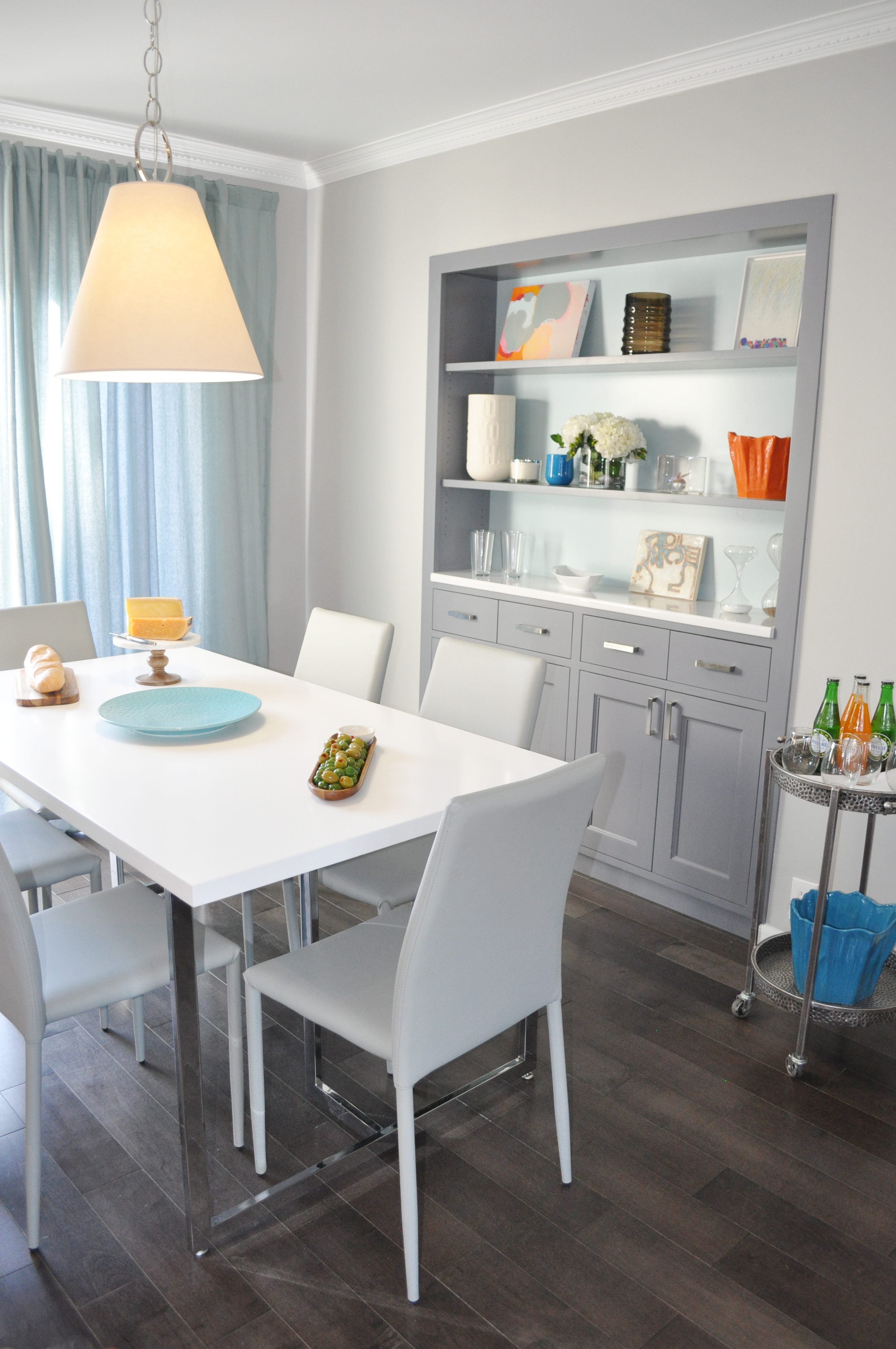 Kim Mitchell Production Designer_HGTV_Buying and Selling with The Property Brothers_Season 3_Episode 316_Dining Room Design_Dining Room Cabinetry_Kitchen Table Pendant Light_Grey Wood Flooring_Kenise Barnes Gallery Art_Grey Cabinets.jpg