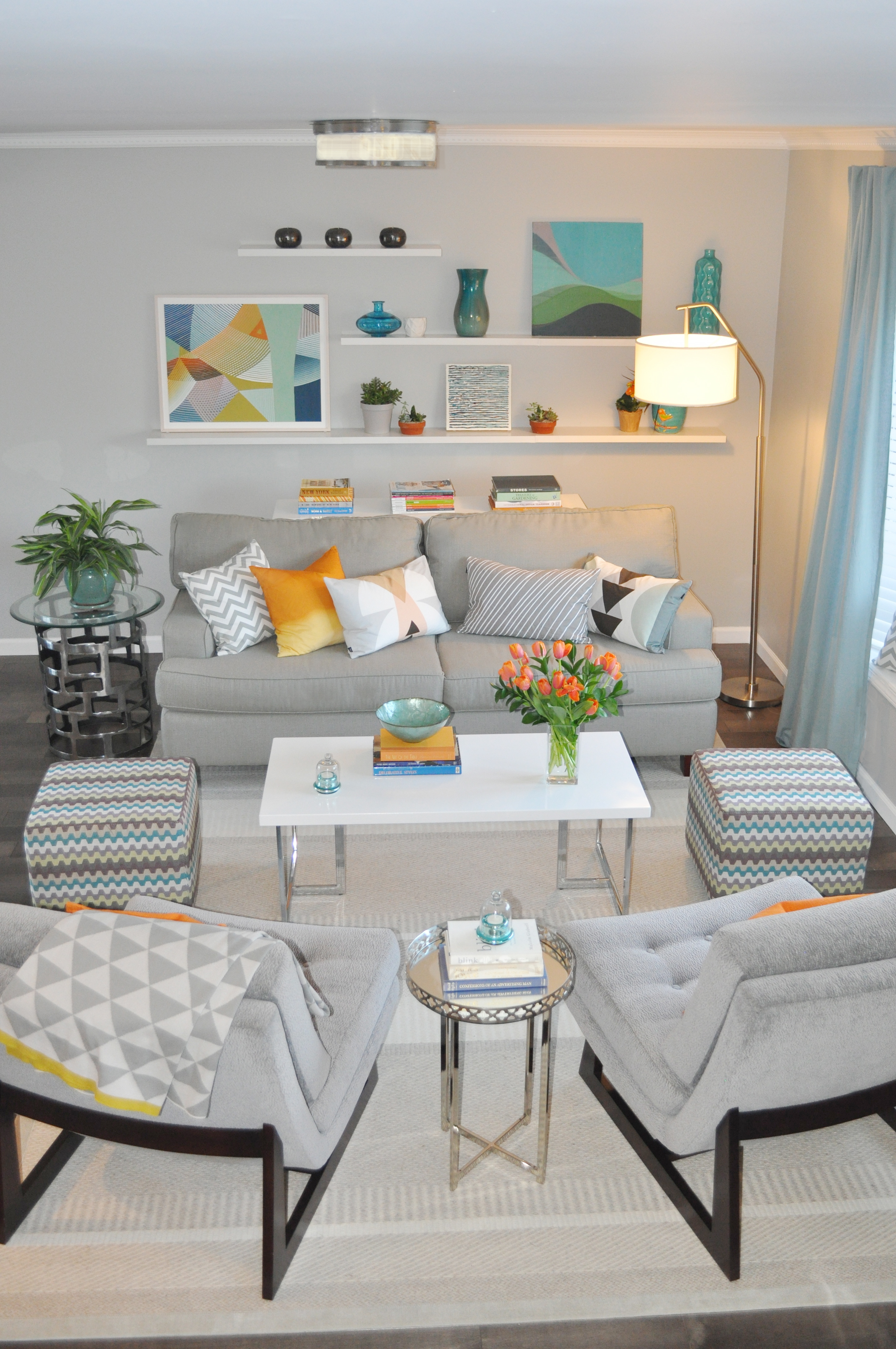 Kim Mitchell Production Designer_HGTV_Buying and Selling with The Property Brothers_Season 3 _Episode 316_Living Room Design_Pop of Color with Gray_Art by Kenise Barnes Gallery_Kontrast_Evas Decorating Chairs_Scandecor Rug_Churchill__Hudson Valley.jpg