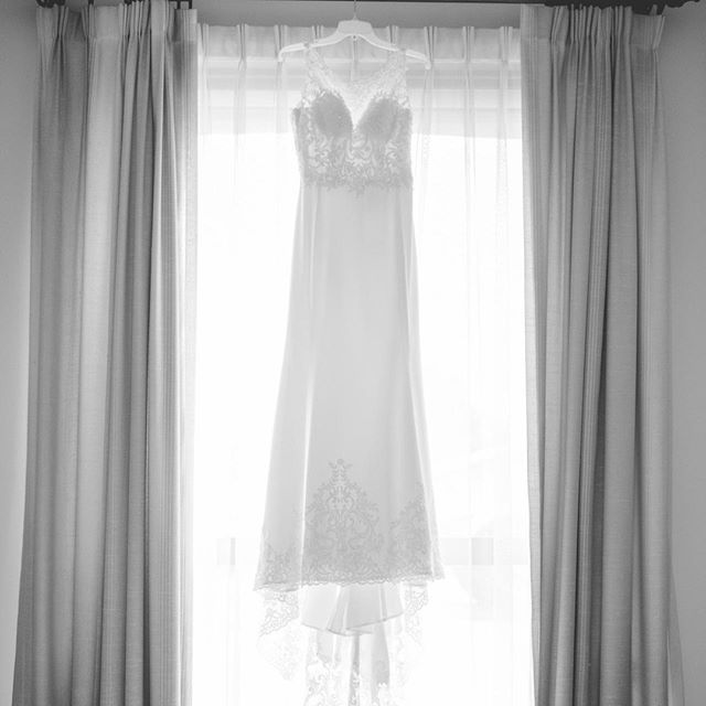 A quintessential wedding dress hanging in a window! Perfection...⁠
⁠
#TCWeddings #TCTeasers