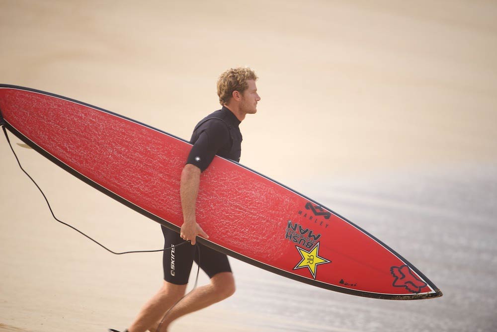   ^ FULLY LOADED GUN  Bede focused on a personal challenge – Waimea Bay.      Courageous  Bede Durbidge is part of a hand full of surfers, a small brigade of elite athletes on the tour, that continually push the limits with total disregard for their 