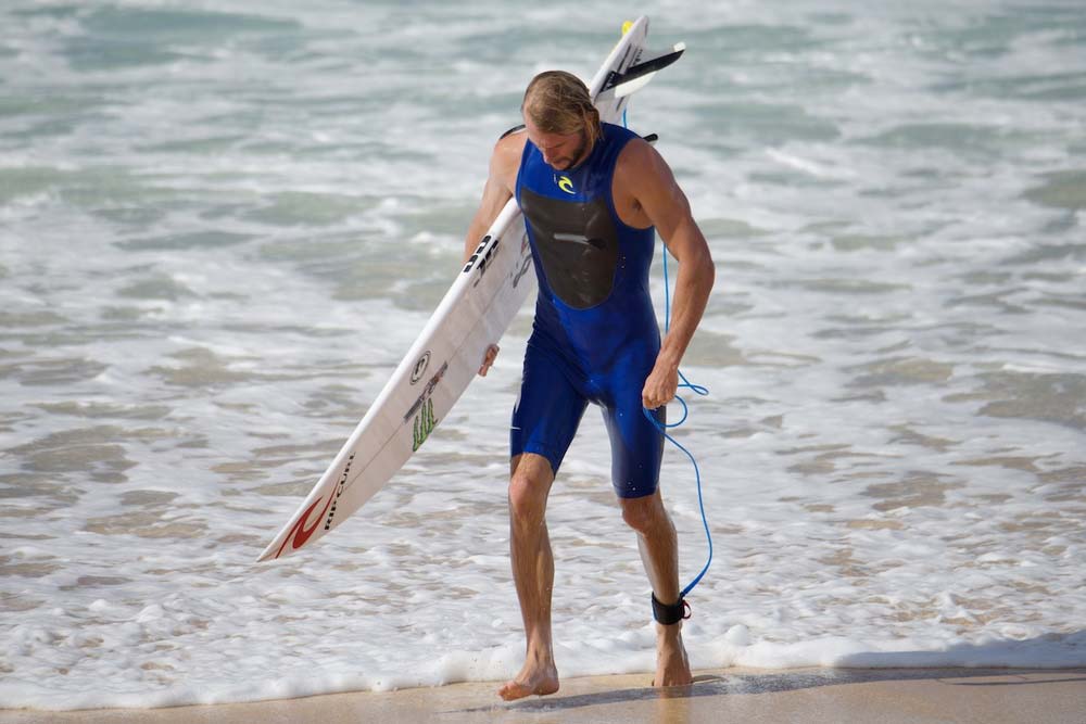   ^ OWEN WRIGHT  At this stage Owen is totally unaware of the severity of the injury that had just incurred. A huge set at Pipeline just cleaned up nearly all the surfers and thrashed them mercilessly. As Owen walks up the beach he comments something