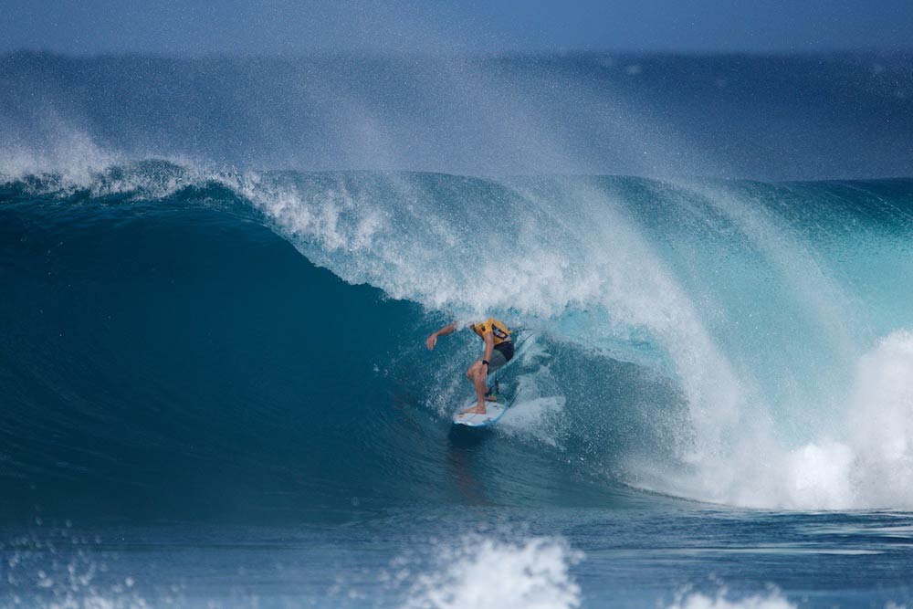   ^ HEAT OF THE DECADE  Mick Fanning goes Backdoor to win the round four  super heat  against Kelly Slater and John John Florence during the Billabong Pipeline Masters. 