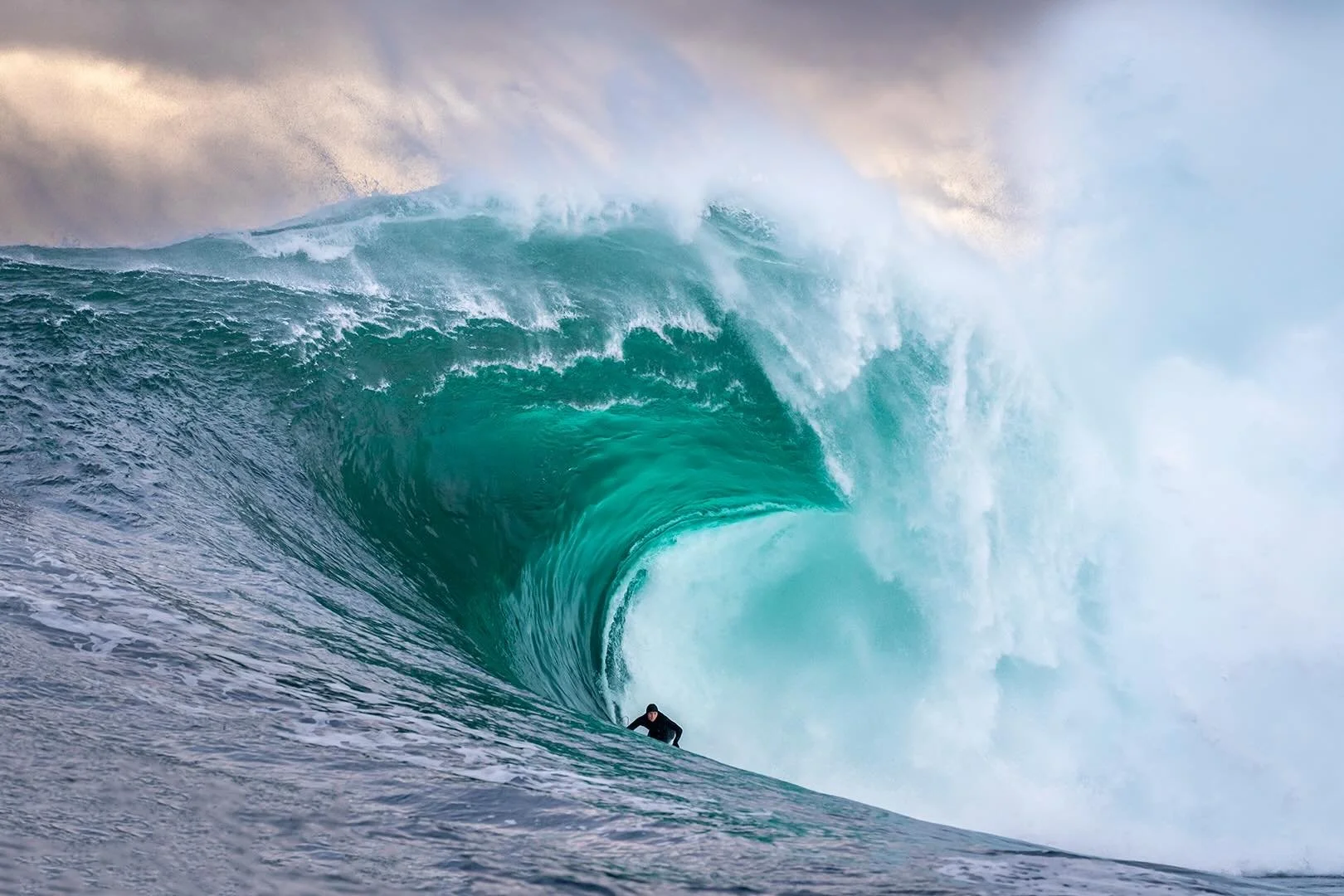 Russell Bierke threads a flawless line beneath a lip I estimate to be at least twelve feet thick. The sheer volume of water, seemingly defying gravity, reveals the immense energy contained within this wave.

Russell, one of the most unassuming profes