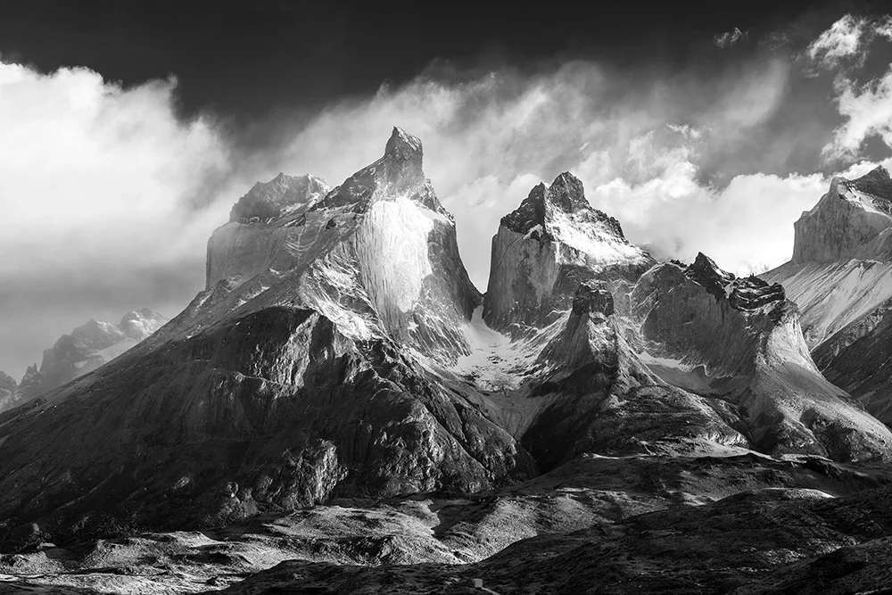 Black-and-white portrait of Torres del Paine’s twin granite peaks, a dramatic tonal study, Patagonia.