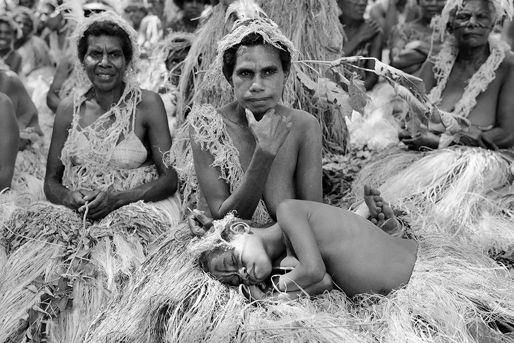 Mother and Child Rest at the Banyan Tree, Tanna Island, Vanuatu.