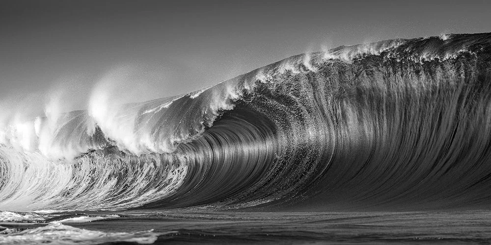 Award Winning Black and White photograph of a Teahupo’o wave forming, liquid texture and sculpted light captured by Ted Grambeau.