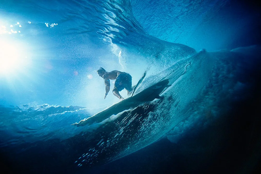 Tahitian local Surfer Manoa Drollet, surfing from deep inside Teahupo`o, photographed from an underwater perspective.