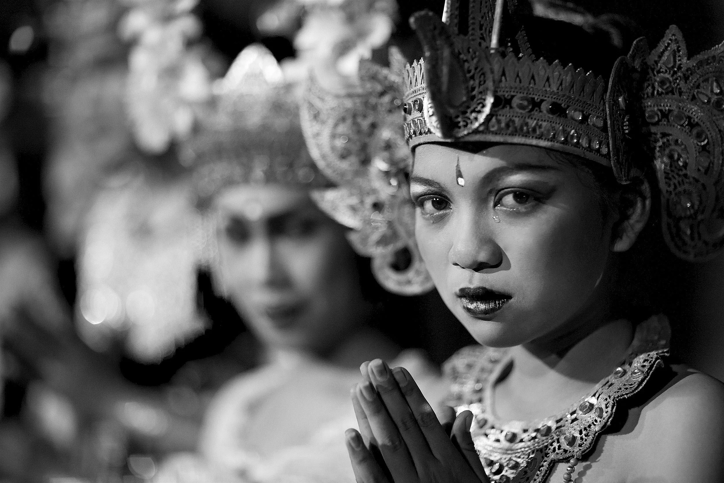 A special moment as a Balinese dancer gazes into the lens with a tear of emotion on her cheek, captured by photographer Ted Grambeau.