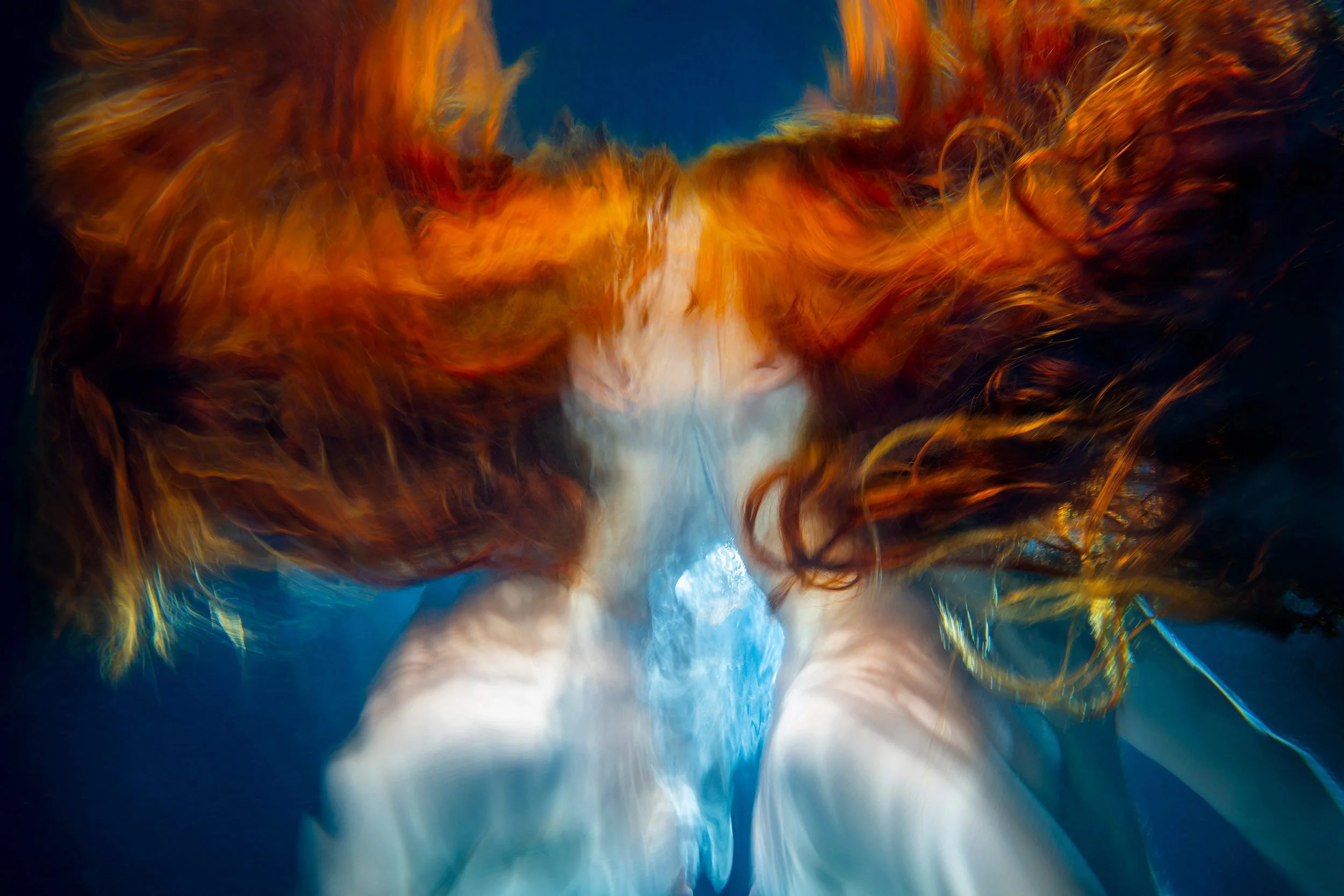 Ethereal Red Hair in reflection, an underwater portrait from the VENUS series, photographed by Ted Grambeau. 