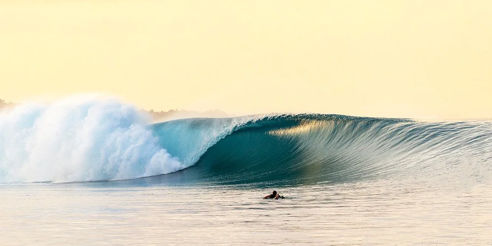 Empty six-foot Mentawai barrel at sunrise - glowing, glassy wave photographed by Ted Grambeau.