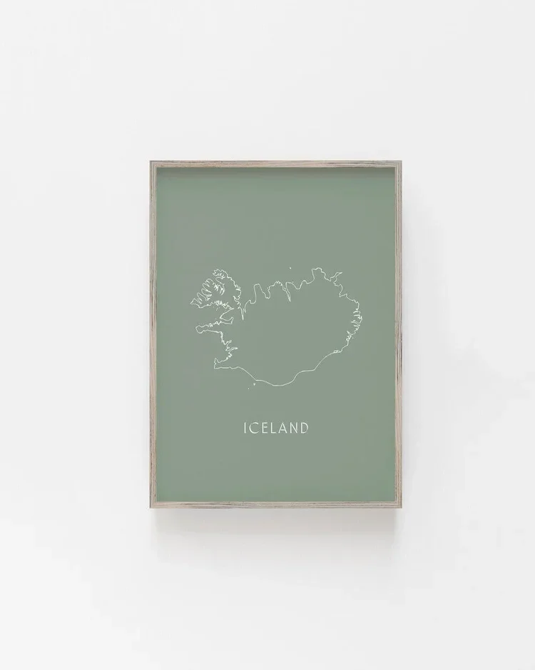 Minimalist framed wall art print of the outline map of Iceland in white line on a muted green background in a Scandinavian style.
