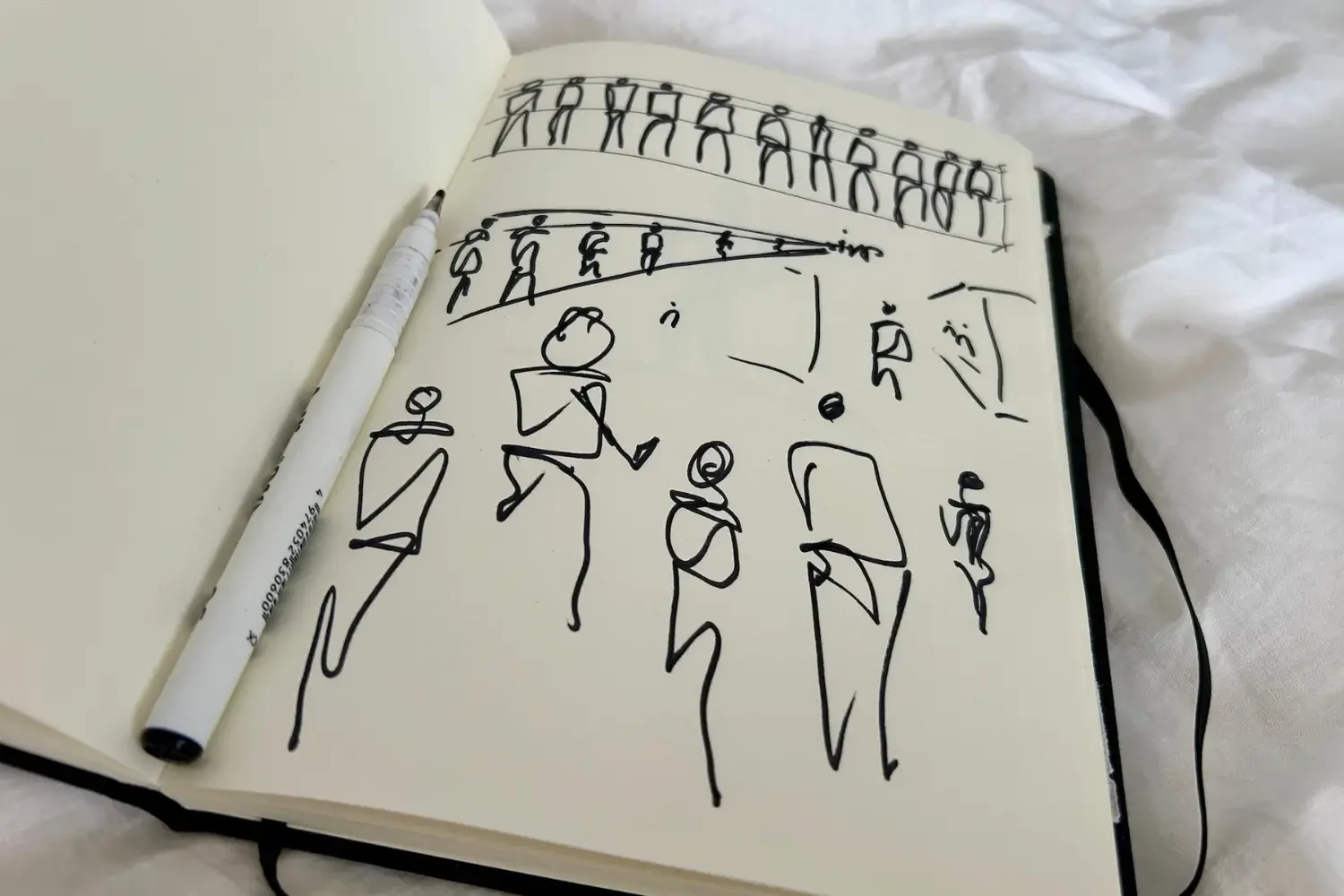 Sketchbook showing simple human figure drawings used for architectural scale and people studies